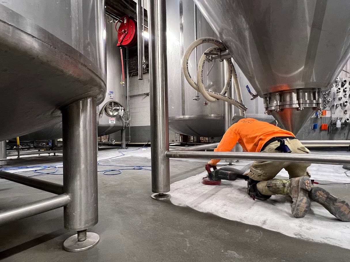 concrete surface being prepped near a industrial Vat